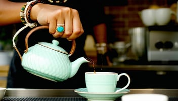 a person pouring into a cup